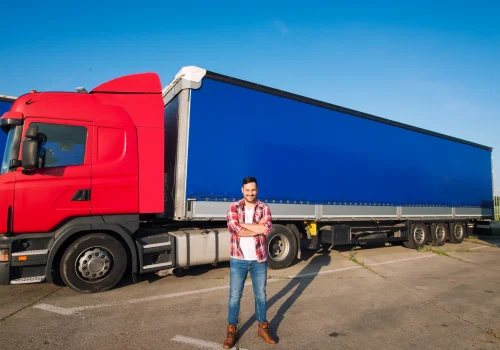 portrait-professional-american-truck-driver-casual-clothing-boots-standing-front-truck-vehicle-with-long-trailer (2)